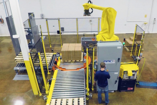 Robotic Frozen Food Case Palletizer being operated by a warehouse employee
