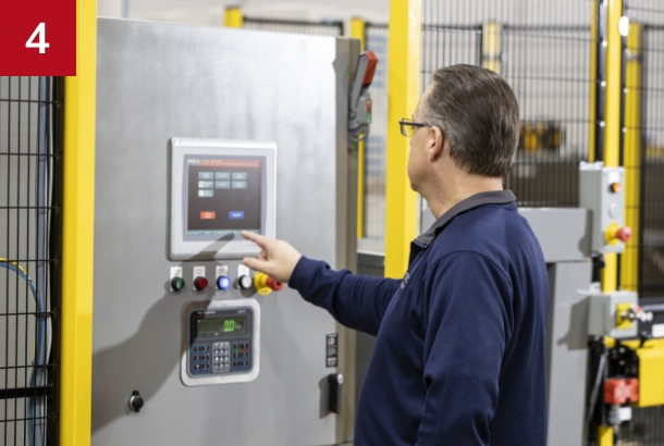 Employee operating a robotic palletizer cell