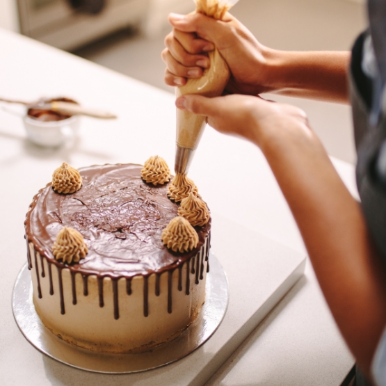 Baker Decorating a Cake